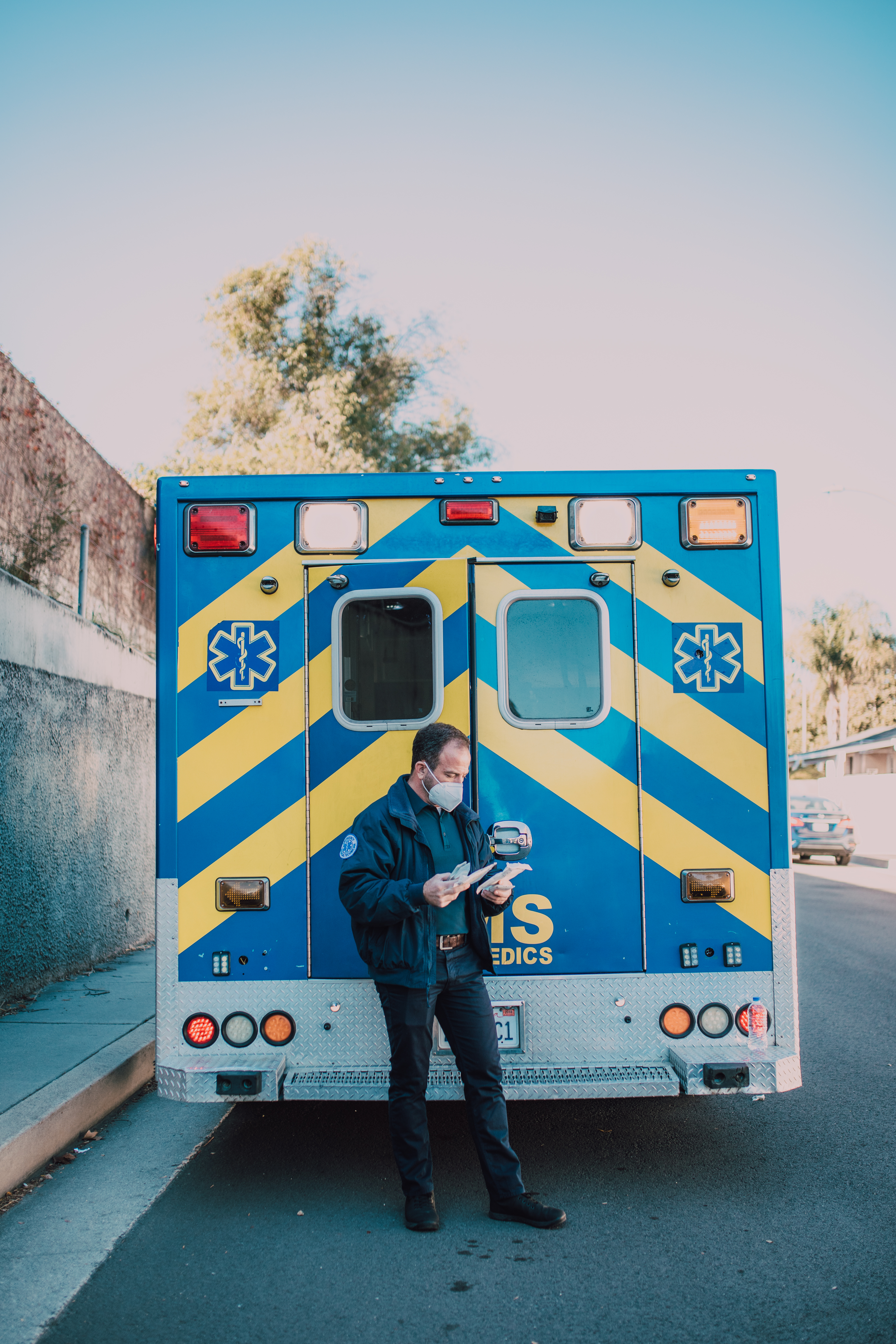 Paramedic Standing Behind an Ambulance